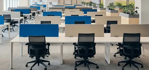 Modern open-plan office space featuring clean workstations, ergonomic chairs, and sanitized carpets provided by professional office cleaning services in Erie, PA.