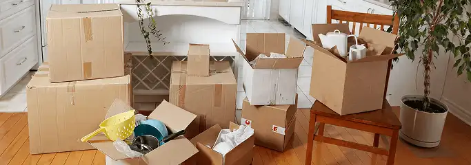 Packed moving boxes and household items in a kitchen before move-out or move-in cleaning, Erie, PA.